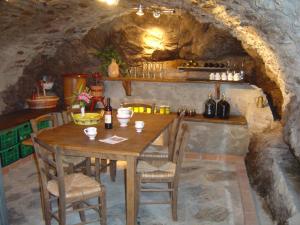 a dining room with a table and chairs in a cave at Rosato in Gravedona