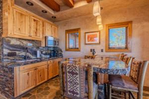 a kitchen with a table and a counter top at Cougar Ridge Resort in Torrey