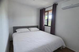 a white bed in a room with a window at Kahlúa Suites in Grote Berg +17 photos