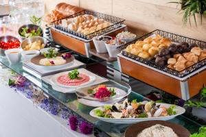 a buffet with different types of food on a table at Art Hotel Asahikawa in Asahikawa +46 photos