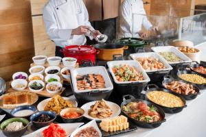 a buffet with many different food items on a table at Art Hotel Asahikawa in Asahikawa