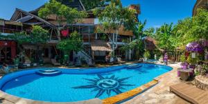 a large swimming pool in front of a building at Serenity Eco Guesthouse and Yoga- CHSE certified in Canggu
