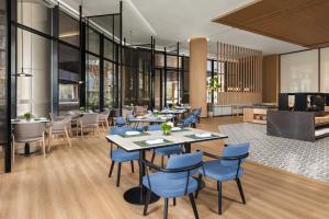 a restaurant with blue chairs and tables and windows at Fairfield by Marriott Deqing in Huzhou