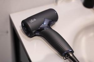 a black hair dryer sitting on top of a table at Private House Hibiki in Nara