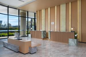 a lobby with a table and large windows at Fairfield by Marriott Deqing in Huzhou