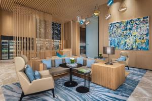 a lobby with a couch and a table and chairs at Fairfield by Marriott Deqing in Huzhou +49 photos