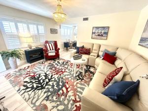 a living room with a couch and a rug at Birdsong Beachfront Condo in St. Pete Beach