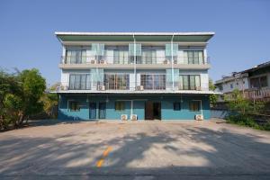 a blue building with a balcony on top of it at V Tharm Hotel in Udon Thani