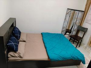 a couch with a blue blanket on top of it at Tulip - Shillong in Shillong +9 photos