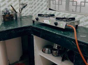 a stove on top of a counter in a kitchen at Tulip - Shillong in Shillong