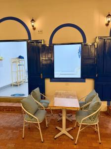 a room with a table and chairs and a screen at Homestay Đan Sam in Ninh Hải