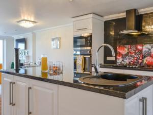 a kitchen with a sink and a counter top at Ailsa Craig View in Stranraer +10 photos