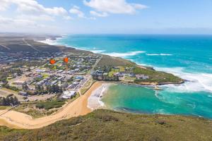 an aerial view of a beach and the ocean at Waves Luxury Suites & Port Central Apartments in Port Campbell +50 photos