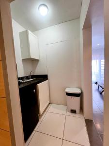 a small kitchen with a black refrigerator and a sink at Dushi Apartments in Willemstad +72 photos