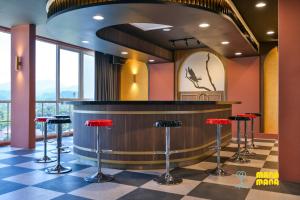 a bar in a restaurant with red stools at Stallionz by Mana Mana in Ipoh +42 photos