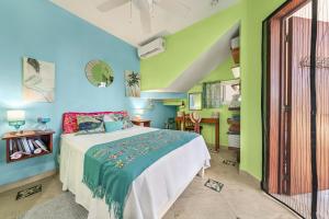 a bedroom with a bed and green walls at Casa Cielo Studio 1 with Tropical Garden Patio in Isla Mujeres