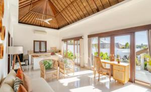 a living room with a couch and a table at Villa Leelavadee in Uluwatu