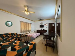 a living room with a couch and a table and a bed at Goa Homeland 3 double bed Calangute in Calangute