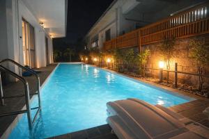 a swimming pool with a lounger in a hotel at night at Machinaka Miyako in Miyako-jima +33 photos