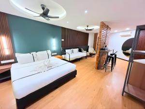 a bedroom with a large bed and a living room at Sky Hotel Cheras Maluri in Kuala Lumpur