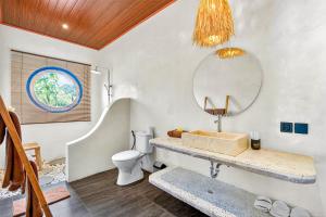 a bathroom with a sink and a mirror at Arch Penida by Bali Cabin in Nusa Penida +50 photos