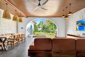 a living room with a couch and a table at Arch Penida by Bali Cabin in Nusa Penida