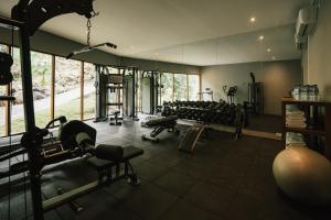 a gym with several treadmills and machines in it at Sanglung Villas & Suites in Kubutambahan