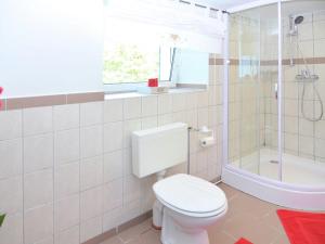 a white bathroom with a toilet and a shower at Gorgeous Apartment in Olsberg near Ski Area in Elpe