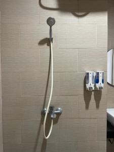 a shower with a shower head in a bathroom at Olivia SOHO Guest House in Legian +52 photos