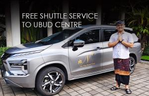 a man standing in front of a silver car at The Ning Resort Ubud in Ubud