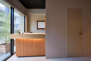 a kitchen with a counter and a window at Hotel Zen in Kyoto