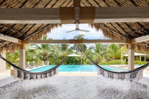 a hammock in a resort with a swimming pool at Finca Los Mangos in Doradal +5 photos