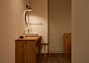a bathroom with a sink and a mirror at Hotel Zen in Kyoto