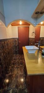 a bathroom with a sink and a counter top at Hostel Küyen Mapu in Comodoro Rivadavia +22 photos
