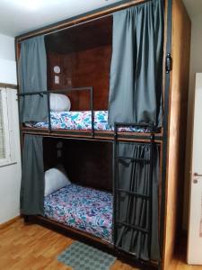 a bunk bed room with two bunk beds in it at Hostel Küyen Mapu in Comodoro Rivadavia