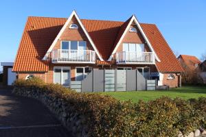 a house with a fence in front of it at Utholmer-Strasse-3 in Brösum