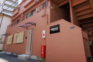 a pink building with a msg sign on it at MKG Home・芝 in Tokyo