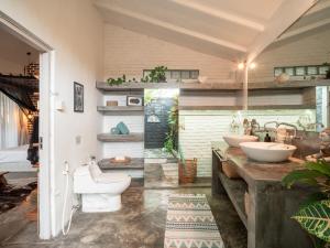 a bathroom with two sinks and two toilets at Lila Boutik Canggu in Canggu