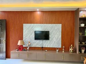 a living room with a large screen tv on a wall at Henritz Apartelle in Sogod