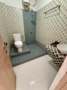 a bathroom with a toilet and a sink at Blue Ocean Hotel in Labuan Bajo +51 photos