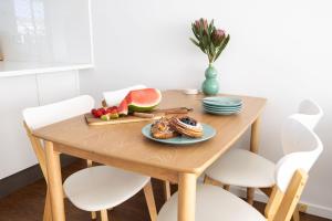 a wooden table with a plate of food on it at 1-45 Beech Street in Evans Head