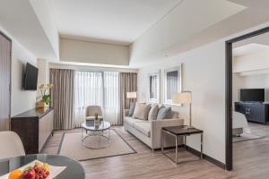 a living room with a couch and a table at Seda Nuvali Laguna near Tagaytay in Santa Rosa
