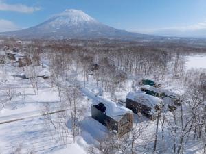an aerial view of a snow covered mountain at Kouzan Woods in Kaributo