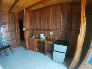 a small wooden room with a sink and a desk at Cocoa Beachfront Inn in Canoa