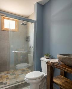 a bathroom with a shower and a toilet and a sink at The Pause EcoCabin Bocas del Toro in Bocas Town