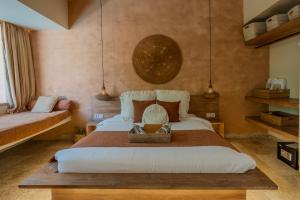 a bedroom with a large bed with a basket on it at Kai Villas Lombok in Kuta Lombok