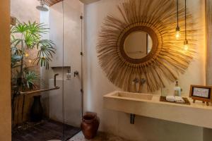 a bathroom with a sink and a mirror at Kai Villas Lombok in Kuta Lombok