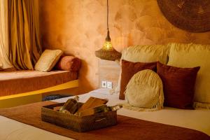 a bedroom with a bed with a suitcase on it at Kai Villas Lombok in Kuta Lombok