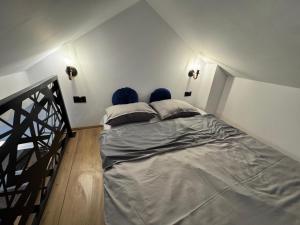 a large bed in a room with a staircase at Apartment Star 2 Ledine in Beograd