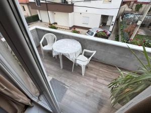 a balcony with a table and chairs on a patio at Apartment Star 2 Ledine in Beograd